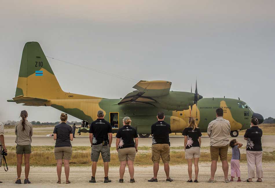 Rhino Without Borders team standing in front of the BDF C130 aircraft – courtesy of Wayne Raymond